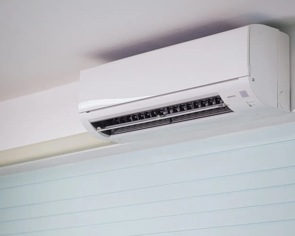 A wall-mounted split air conditioner indoor unit in a home